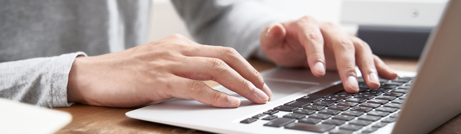 Close up of hands on a laptop.